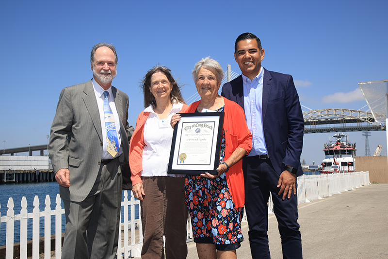 With the Gerald Desmond Bridge in the background, Gerald Desmond Jr., Desmond family members Eileen Bryson and Margaret Bomberg, and Long Beach Mayor Robert Garcia, from left, mark the official retirement of the Gerald Desmond Bridge at a ceremony in the Port of Long Beach on Saturday.